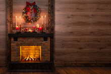 Many Gift Boxes Near The Christmas Fireplace In A Festive Interior Of A Log Cabins With Wooden Walls. Mantelpiece With Candles, Christmas Wreath With Bells