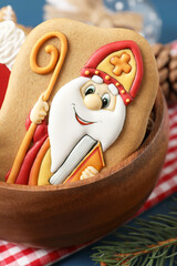 Wall Mural - Tasty gingerbread cookie on table, closeup. St. Nicholas Day celebration