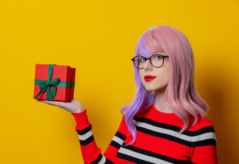 Wall Mural - girl with purple hair in red striped sweater with gift box