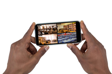 Poster - Hand of african american man holding smartphone with view of library from security cameras on screen