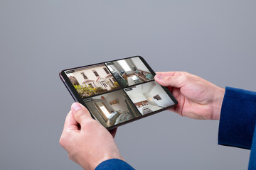 Poster - Hands of caucasian man holding tablet with view of home from security cameras on screen