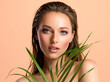 © Valua Vitaly - White woman with healthy skin of body and palm leaves. Tanned body of an attractive girl with green plants. Large palm leaves cover the breast.
