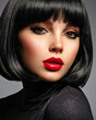 Beautiful brunette girl with red lips and black bob hairstyle. Pretty young woman with black hair. Closeup portrait of a model with bright makeup on a face. Fashion portrait of a pretty lady.