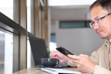 Sticker - Smartphone is used by a man. A businessman is at work in his office. Freelancing, student life, e-learning, studying, web site, technology.