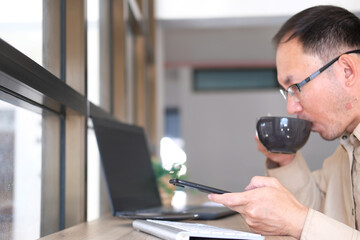 Sticker - Businessman types on a computer keyboard at a wooden desk. Banking and strategy development A financial analyst is at work in the workplace. Business accounting and project management