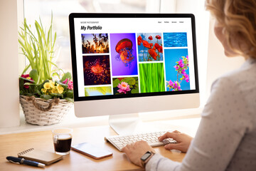 woman viewing photography portfolio website on computer screen