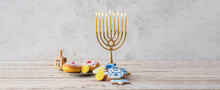 Tasty Cookies And Donuts For Hanukkah Celebration With Menorah On Light Background With Space For Text