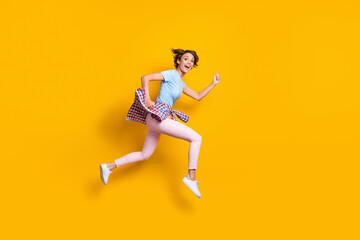 Sticker - Photo portrait full side body view of funny woman running with tight waist shirt jumping up isolated on vivid yellow colored background