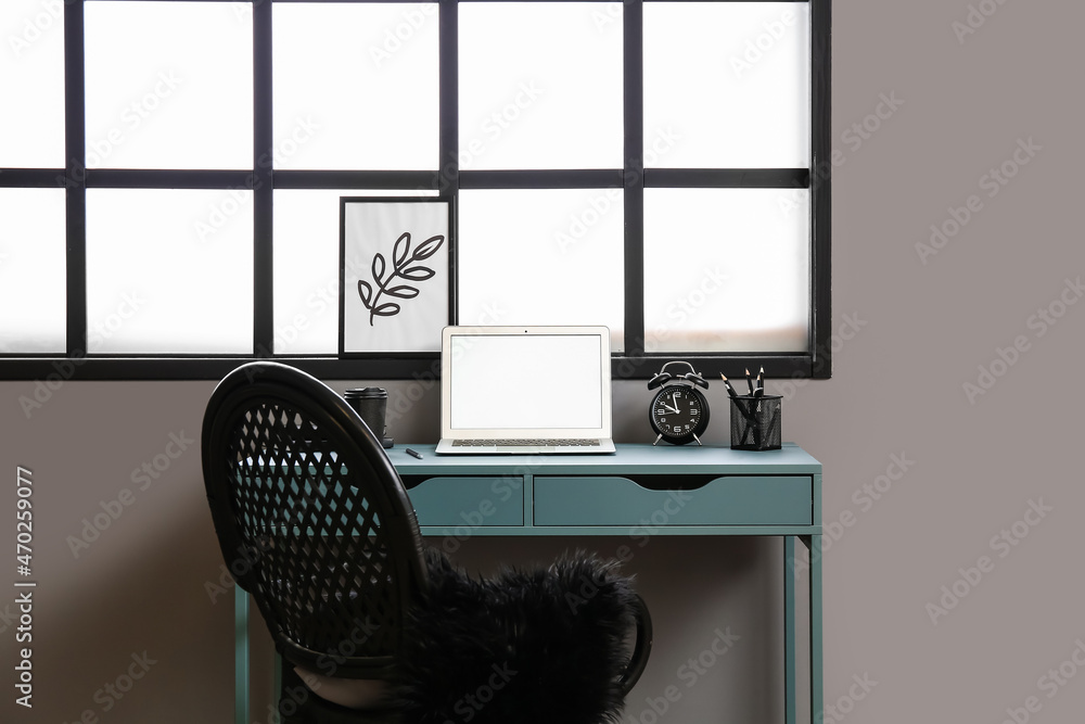 Comfortable workplace near window in interior of room