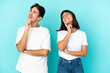 © luismolinero - Young mixed race couple isolated on blue background thinking an idea while looking up