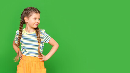 Wall Mural - Kid on an isolated background. The smiling little girl looks away. Copy space.