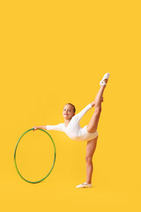 Wall Mural - Little girl doing gymnastics with hula hoop on color background