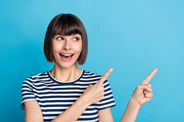 Wall Mural - Photo of young amazed happy positive woman look point finger empty space isolated on blue color background