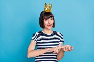 Poster - Photo of nice brunette young lady count wear crown striped t-shirt isolated on blue background