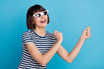 Wall Mural - Photo of funky brunette young lady dance wear spectacles striped t-shirt isolated on blue background