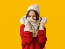 Young Woman In Stylish Winter Clothes On Color Background