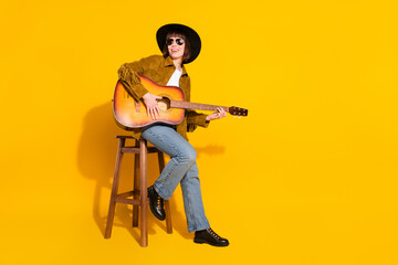 Canvas Print - Photo of charming cute woman dressed cowboy clothes spectacles cap singing playing guitar empty space isolated yellow color background