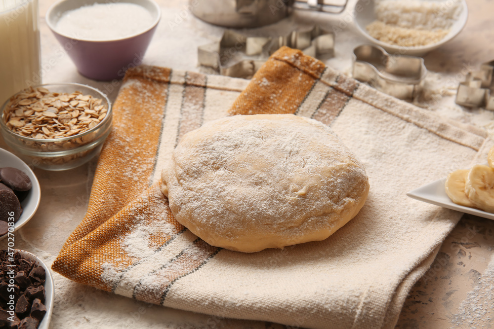 Fresh dough for preparing homemade cookies on beige background