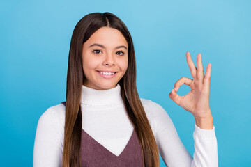 Poster - Photo of young lovely little girl show okey symbol approve quality ads isolated over blue color background