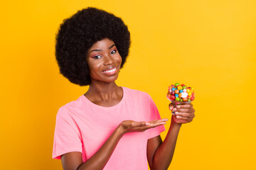 Poster - Photo of young black girl happy positive smile advert advice present delicious candy isolated over yellow color background