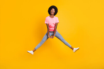 Sticker - Full size photo of joyful millennial lady jump wear pink t-shirt jeans isolated on yellow color background