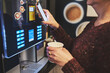 © Przemek Klos - Woman paying for product at vending machine using smartphone