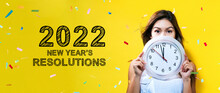 2022 New Years Resolutions With Young Woman Holding A Clock Showing Nearly 12