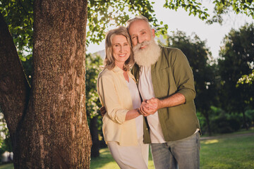 Canvas Print - Photo of wife husband happy old couple wear sportswear dance hold hands smile outdoors outside park in forest