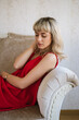 © STUDIO TAURUS - Portrait of beautiful blond young woman wearing red dress