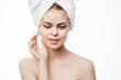 © VICHIZH - cheerful woman with a white towel on her head face cream skin care