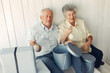 © prostooleh - Elegant old couple sitting at home with christmas gifts