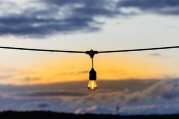 electric lamp on the background of the sunset sky