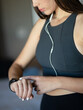 Young woman wearing fitness sportswear checking smartwatch for run workout