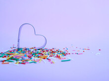 Multi-colored Confetti In The Shape Of A Heart. Party Idea. Valentine's Day. The 14th Of February. Pink Background. Place For Text