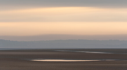 Wall Mural - beautiful sunrise landscape image of talacre beach at surnise with dramatic sky and clouds