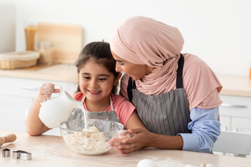 Wall Mural - Cooking Together. Muslim Mother Baking With Her Little Daughter In Kitchen