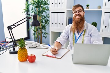 Poster - Young redhead man wearing dietician uniform working at clinic