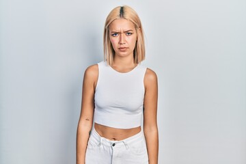 Poster - Beautiful blonde woman wearing casual style with sleeveless shirt skeptic and nervous, frowning upset because of problem. negative person.