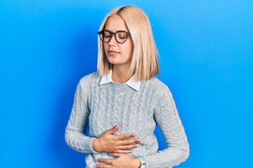 Wall Mural - Beautiful blonde woman wearing glasses with hand on stomach because indigestion, painful illness feeling unwell. ache concept.