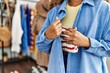 © Krakenimages.com - Young latin robber woman stealing handbag at clothing store.