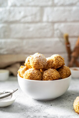 Wall Mural - Homemade coconut cookies in a white plate on a light gray culinary background