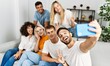 © Krakenimages.com - Group of young friends smiling happy making selfie by the smartphone at home.