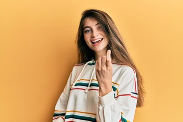 Sticker - Young caucasian woman wearing casual clothes beckoning come here gesture with hand inviting welcoming happy and smiling