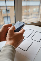Wall Mural - designer is developing a ux mobile application wireframe. sketch, prototype, framework, layout futur