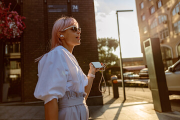 Young woman listening to music on the street