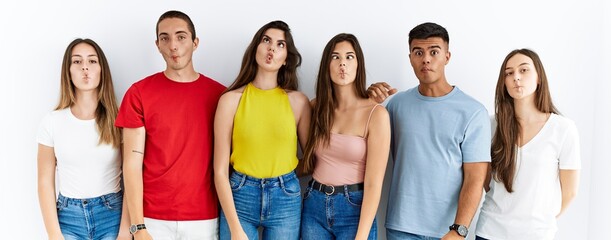 Canvas Print - Group of people wearing casual clothes standing over isolated background making fish face with lips, crazy and comical gesture. funny expression.