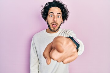 Poster - Handsome hispanic man wearing casual white sweater pointing displeased and frustrated to the camera, angry and furious with you