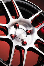 A Fragment Of Red Alloy Wheels, Spokes, Wheel Nuts And Details Of A Sports Car Wheel Close-up On A Red Background , A Symbol Of Auto Tuning Of A Car Service Or Sports Racing