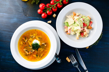 Poster - Side view of a two course meal, served on a wooden table