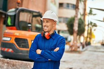 Young caucasian worker smiling happy wearing uniform at the city.